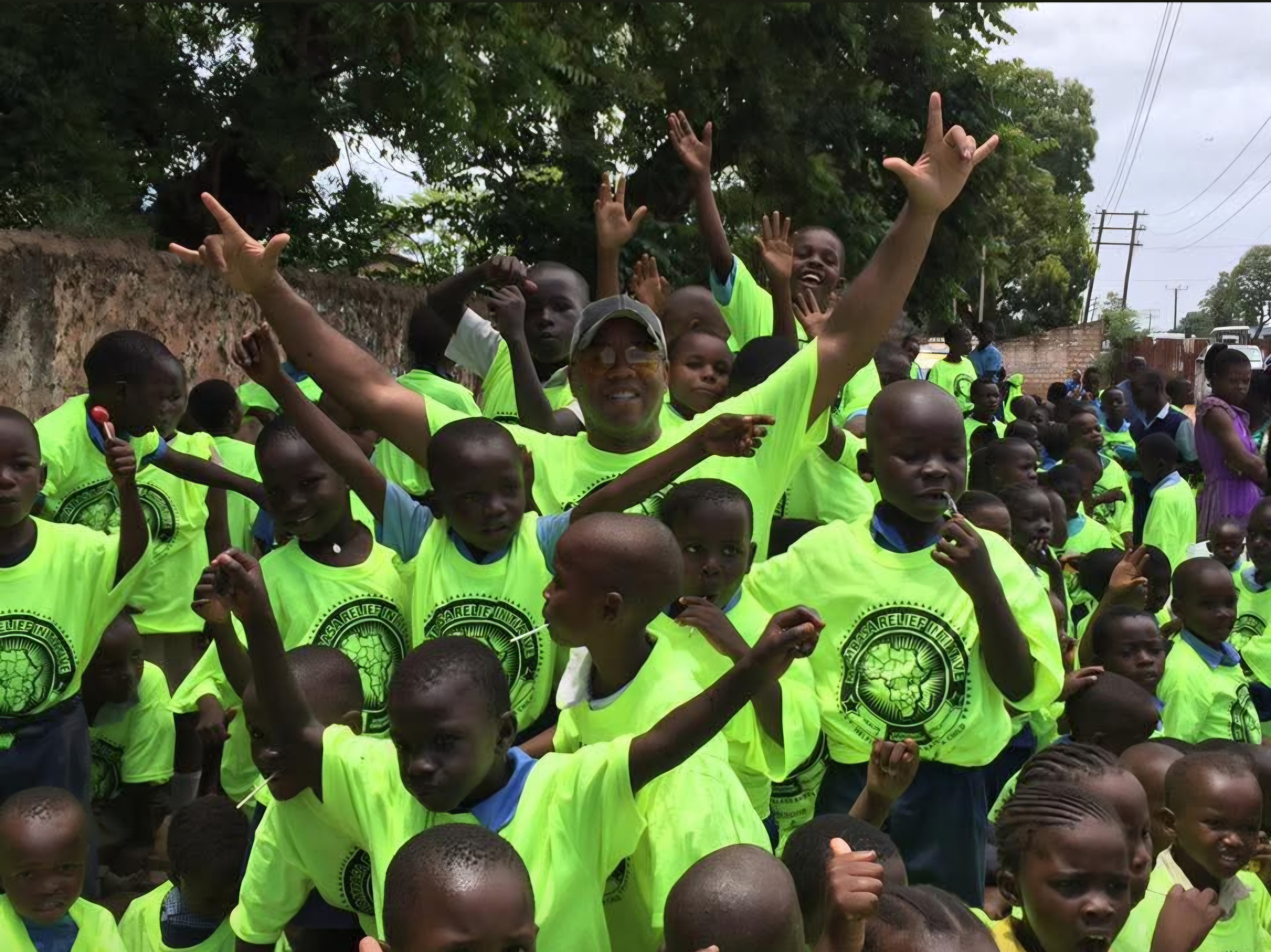 Students in bright green shirts gathered outdoors
